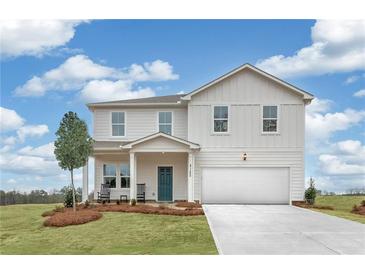Two-story house with white siding, green door, and a two-car garage at 3621 Olive Grove Ln, Covington, GA 30016