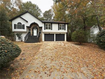 Two-story house with a double garage and driveway at 2827 Candler Sw Run, Marietta, GA 30064