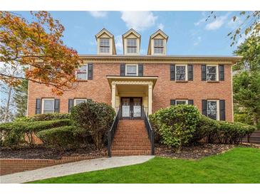 Two-story brick home with landscaping and steps at 9070 Twelvestones Dr, Roswell, GA 30076