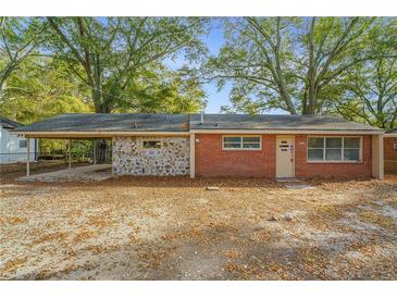 Brick ranch home with stone accents and a carport at 2291 Perkerson Mill Rd, Austell, GA 30106