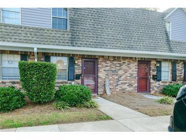 Brick front exterior of townhome with landscaping and walkway at 3103 Reeves Se St, Smyrna, GA 30080