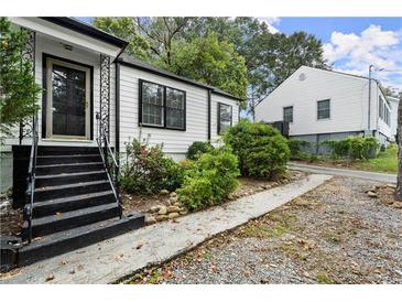 Charming white house with black accents and a well-maintained yard at 4118 Clairmont Rd, Chamblee, GA 30341