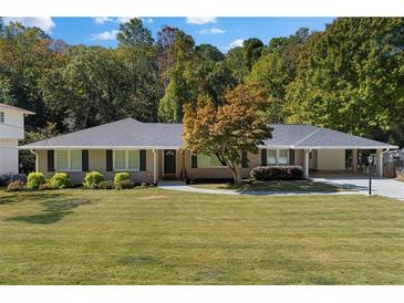 Ranch home with landscaped yard and attached carport at 720 Starlight Ln, Atlanta, GA 30342