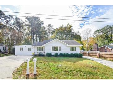 Charming white ranch home with well-manicured lawn at 220 Hicks Se Dr, Marietta, GA 30060