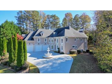 Elegant two-story house with a three-car garage and fountain at 5955 Tibor Nw Dr, Acworth, GA 30101