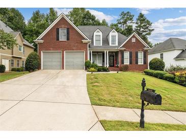 Brick house with two-car garage and manicured lawn at 143 Templeton Ln, Villa Rica, GA 30180