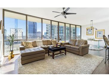 Spacious living room with floor to ceiling windows, offering stunning city views at 700 Park Regency Ne Pl # 1504, Atlanta, GA 30326