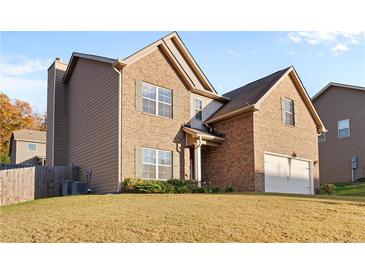 Two-story brick home with a large yard and attached garage at 220 Tracewind Pl, Atlanta, GA 30349