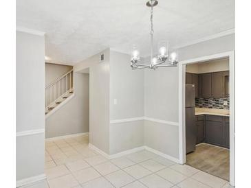 Bright dining room with tile floors and a view of the kitchen at 6429 Woodstone Way, Morrow, GA 30260