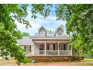 Two story house with front porch and stone base at 160 Cross Rd, Covington, GA 30016