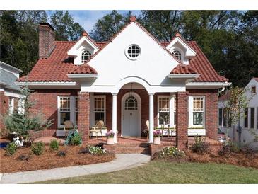 Charming brick home with red tile roof and a welcoming front porch at 1214 Cameron Ne Ct, Atlanta, GA 30306