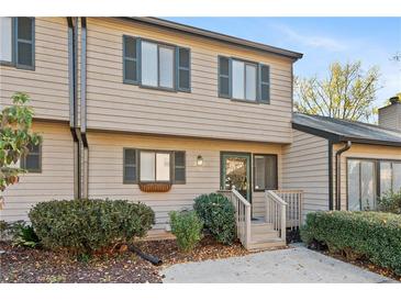 Two story townhome with light beige siding and green shutters at 518 Gardenia Ln, Marietta, GA 30068