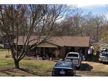 Ranch style home with brown roof and mature trees at 4706 Piney Grove Rd, Cumming, GA 30040