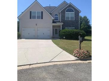 Two-story house with two-car garage and landscaping at 2118 Water Mill Ct, Buford, GA 30519