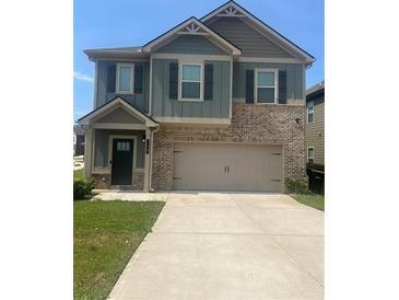 Two-story home with brick and siding exterior; two car garage at 11967 Brightside Pkwy, Hampton, GA 30228