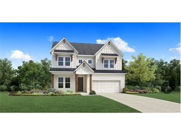 Two story craftsman style home with large windows and a three car garage at 5063 Baywood Ln, Woodstock, GA 30188