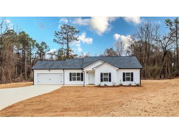 White house with gray roof, attached garage, and landscaping at 192 Old Brock Rd, Rockmart, GA 30153