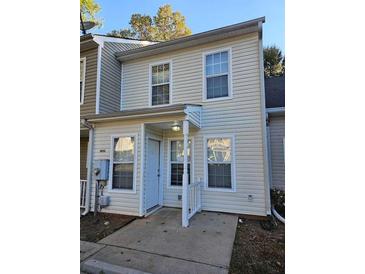 Two-story beige townhome with white trim and landscaping at 6500 Wellington Chase Ct, Lithonia, GA 30058