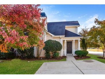 Tan siding house with dark door, walkway, and landscaping; autumn leaves at 6315 Wellington Walk Way, Lithonia, GA 30058