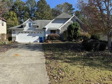 House exterior with two-car garage and landscaping at 2820 Brookford Sw Ln, Atlanta, GA 30331
