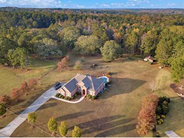 Aerial view of home on large lot with mature trees at 620 Springview Dr, Covington, GA 30014