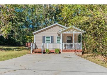 Charming one-story house with a covered porch and spacious driveway at 3464 Linecrest Rd, Ellenwood, GA 30294