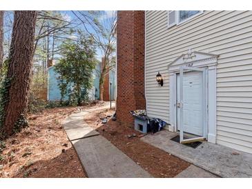 Townhouse exterior with walkway and front entrance at 1167 Greenyard Way, Norcross, GA 30093