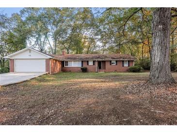 Brick ranch house with attached garage and large yard at 2273 Hampton Locust Grove Rd, Locust Grove, GA 30248