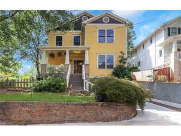 Beautiful two-story yellow house with front porch and landscaping at 393 Georgia Se Ave, Atlanta, GA 30312