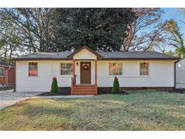 Charming white house with brown accents, a wooden porch, and well-manicured lawn at 2349 Springdale Sw Rd, Atlanta, GA 30315