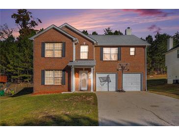 Brick two-story house with a two-car garage and a basketball goal at 6634 Pine Valley Trce, Stone Mountain, GA 30087