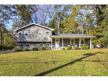 Gray house with white trim, front porch, and landscaped lawn at 4246 Antler Se Trl, Smyrna, GA 30082