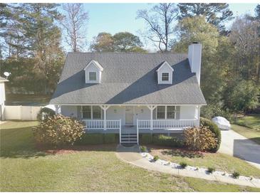 White house with gray roof, front porch, and landscaping at 4207 Alaina Cir, Austell, GA 30106