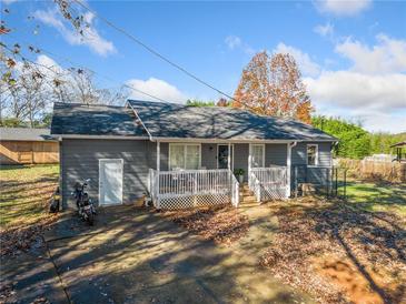 Gray house with a white porch and a spacious yard at 51 Jennifer Ln, Rydal, GA 30171