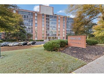 Brick building exterior, landscaping, and parking lot at 130 26Th St # 706, Atlanta, GA 30309