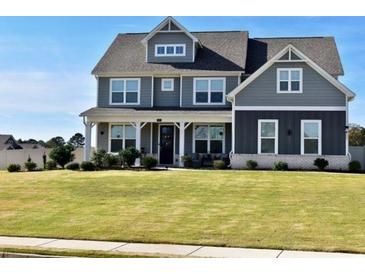 Two story home with gray siding, white trim, and a large front yard at 100 Leveret Rd, Locust Grove, GA 30248