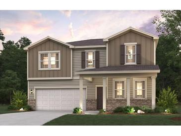 Two-story home with neutral siding, brick accents, and a two-car garage at 4175 Viola Pl, Atlanta, GA 30349