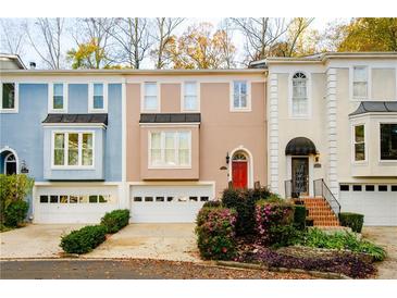 Three-unit townhouse complex with attached garages and landscaping at 3609 E Bay St, Duluth, GA 30096