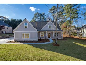 Two-story craftsman home with gray siding, brick accents, and a covered porch at 312 Brook Hollow Ln, Loganville, GA 30052