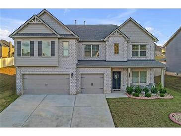 Two story house with gray siding, double garage, and manicured lawn at 189 Osier Dr, Mcdonough, GA 30252