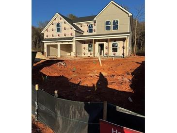 Two story house with a gray exterior, stone accents, and a two car garage at 217 Orwell Dr, Social Circle, GA 30025
