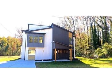 Modern two-story home with gray and white exterior, attached garage, and landscaped lawn at 479 Lee Sw Rd, Mableton, GA 30126