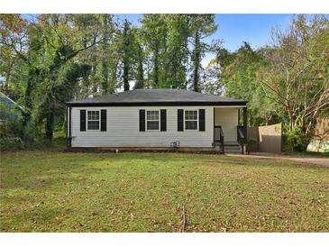 Charming house with white siding, black shutters, and a spacious lawn at 1642 Cecilia Se Dr, Atlanta, GA 30316