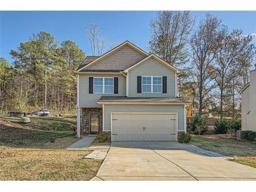 Two-story house with gray siding, a two-car garage, and stone accents at 21 Old Country Trl, Dallas, GA 30157