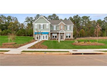 Two-story home with gray siding, brick accents, and a landscaped lawn at 236 Ruthe Cvs, Locust Grove, GA 30248