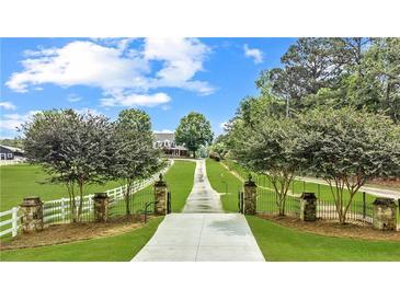 Long driveway leading to a charming two-story home at 2054 Cook Rd, Oxford, GA 30054