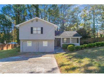 Gray two-story house with a two-car garage and a landscaped yard at 5382 Kemper Pl, Stone Mountain, GA 30088