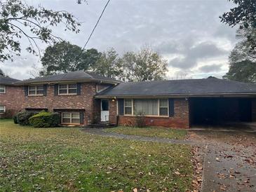 Brick ranch house with carport and landscaped lawn at 3227 Clifton Church Se Rd, Atlanta, GA 30316