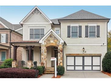 Two-story house with stone accents and a three-car garage at 3329 Stetson Overlook Se, Smyrna, GA 30080