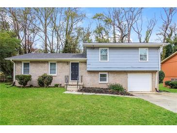 Brick ranch house with attached garage and landscaped lawn at 3900 Emerald North Dr, Decatur, GA 30035